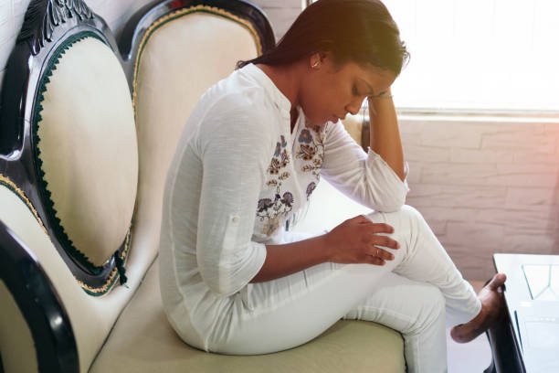 istock woman crying while sitting in an armchair 1323757906