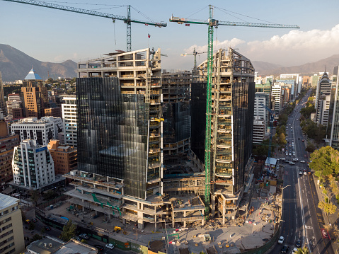 Aerial view of modern skyscrapers construction site in El Golf neighborhood at sunset in Santiago de Chile
