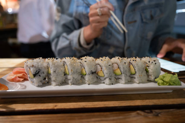 istock Unrecognizable woman eating vegetarian sushi 1323759710