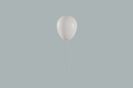 A single white balloon floating in front of a gray background.