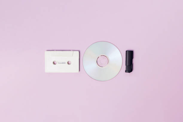 White radio cassette for cassette player and cd and black usb flash memory on a purple background