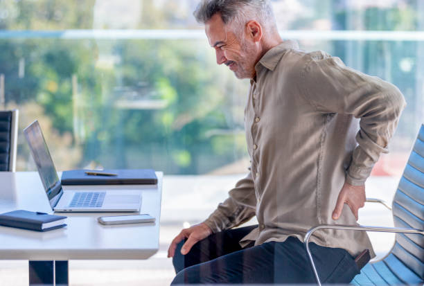 istock Mature business man with holding his back in pain. 1323765741