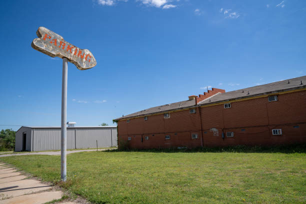 istock Old rusty generic parking sign with an arrow points to a grassy field 1323765840