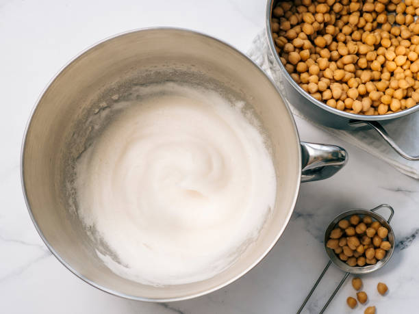 Whipped chickpea aquafaba in planetary mixer bowl