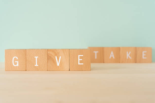 istock Give and take; Wooden blocks with 