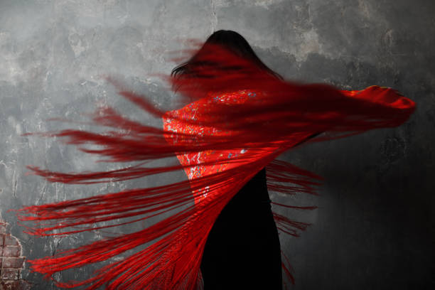 Young adult spanish woman dancing flamenco on gray vintage background Young adult spanish woman dancing flamenco on gray vintage studio background black shawl wrap stock pictures, royalty-free photos & images