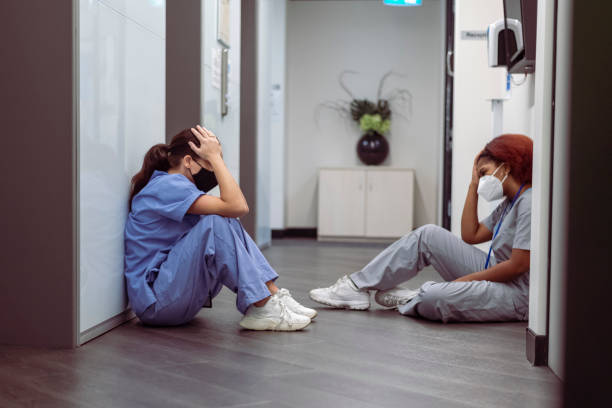 exhausted nurses take a break from their stressful shift - nurse hygiene emotional stress surgeon imagens e fotografias de stock