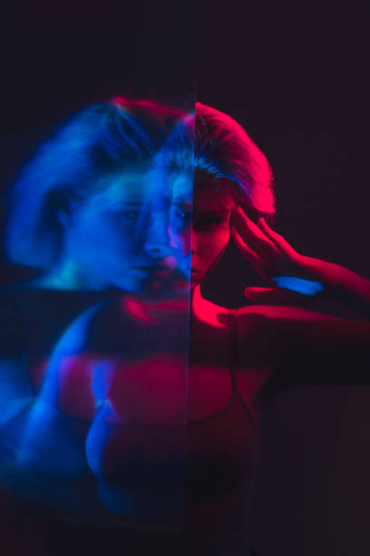 istock mental disorder disturbed woman in pink blue light 1323773673