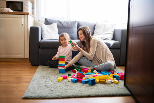 istock Mother playing with her daughter at home. 1323773828