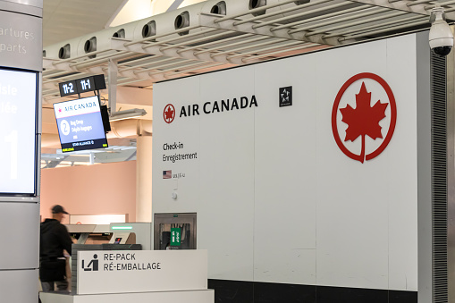 An Air Canada check-in counter is seen inside Toronto Pearson Int'l Airport at night. Air Canada is Canada's largest airline, the country's flag carrier and a member of Star Alliance, the largest global airline alliance.
