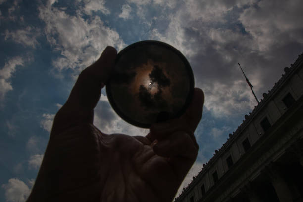 istock Solar eclipse in New York City: Sun stellar corona inside the neutral density filter ring against the USPS building near 34th Street and 8th Avenue, Penn Station area 1323783766