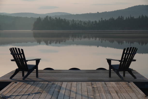 beautiful light across the mountains and calm lake from a quiet dock