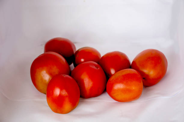 istock A bunch of red tomato and white Background 1323789979