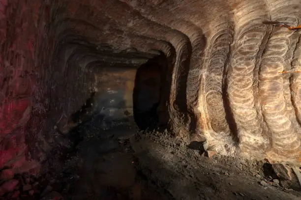 Underground mine. Dead-end mining. The walls show the marks of the roadheader drill bit.