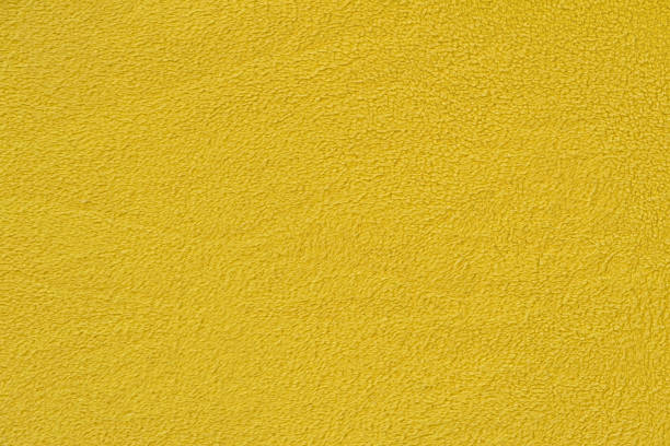 Yellow background with a textural surface Yellow background with a textural surface. Yellow fabric, fleece. fleece photos stock pictures, royalty-free photos & images