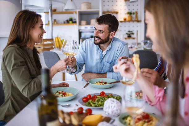 istock Friends enjoying time together while eating 1323799466