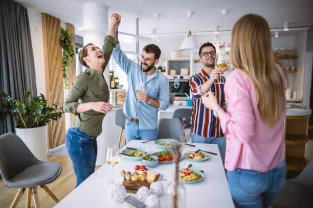 istock Friends having fun dining together at home 1323800085