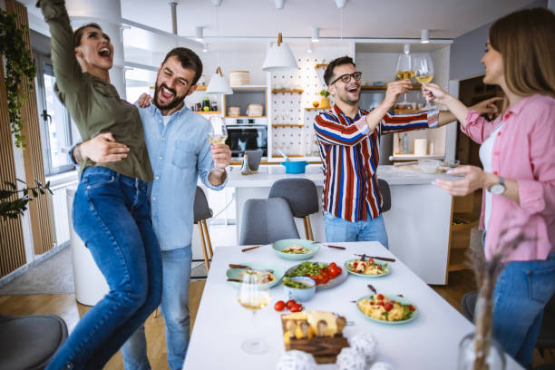 istock Friends having fun dining together at home 1323800101