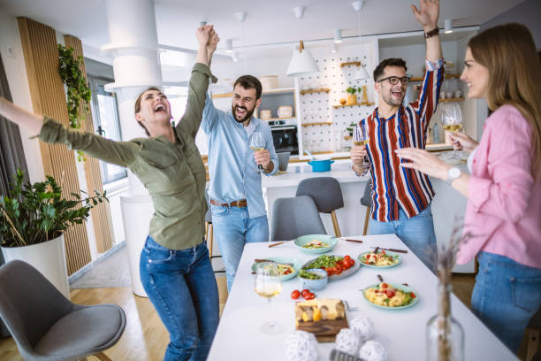 istock Friends having fun dining together at home 1323800479