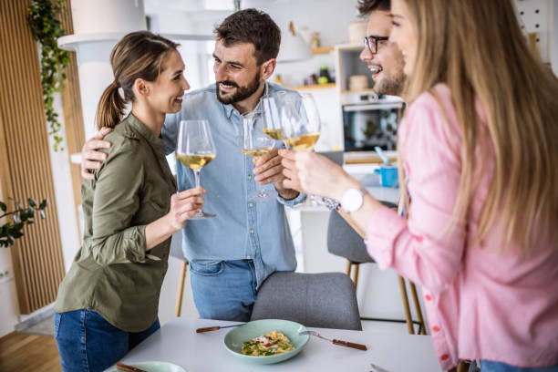 istock Friends toasting with wine at home 1323801167