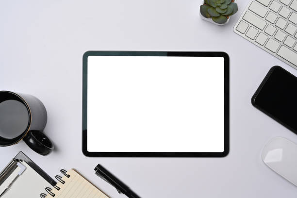 istock Top view digital tablet, smart phone and office supplies on white background. 1323803331