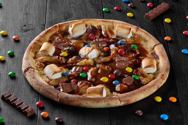istock Sweet pizza with caramelized banana, marshmallow, chocolate dragee 1323805852