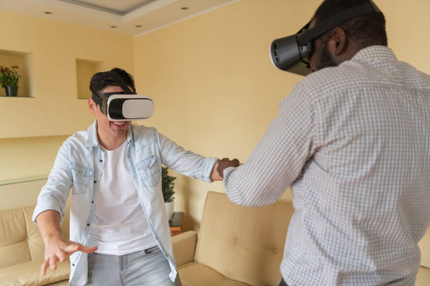 istock A Bearded Afro-American and his Friend are Playing Game Using a Virtual Reality Simulator. 1323810245