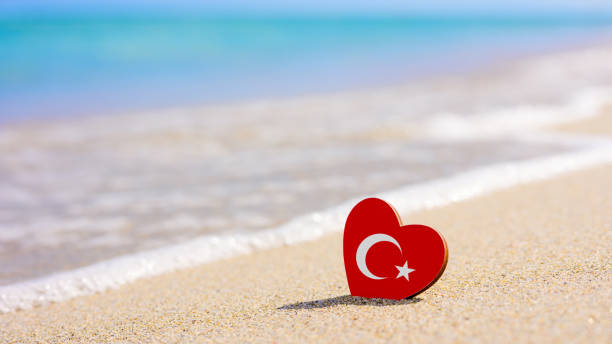 Turkish flag in the shape of a heart on a sandy beach. Turkish flag in the shape of a heart on a sandy beach. The concept of the best vacation in Turkey alanya stock pictures, royalty-free photos & images