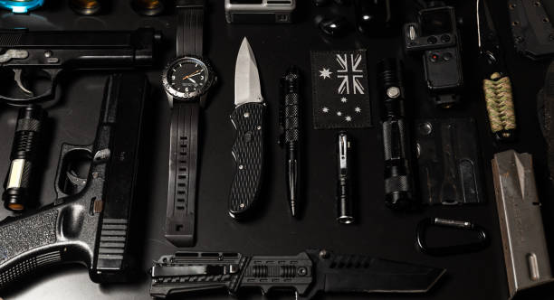 istock Tactical and EDC gear flat lay on black (Every day carry) 1323812478