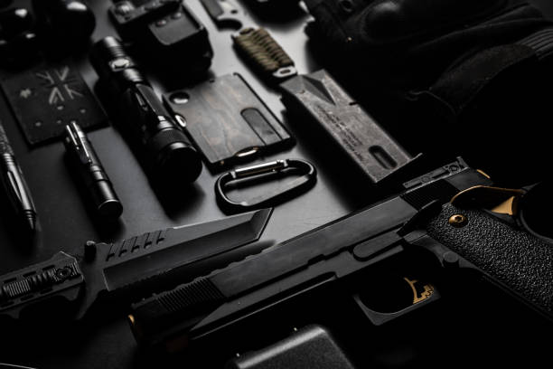 istock Tactical and EDC gear flat lay on black (Every day carry) 1323812489