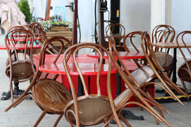 istock Street cafe with empty tables and folded chairs outdoor 1323812662