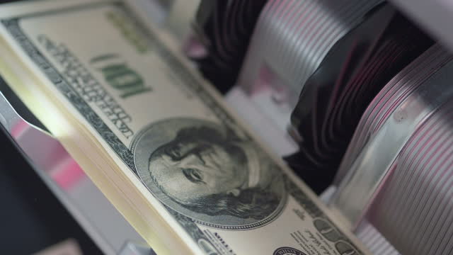 Machine counter automatic calculates a large amount of Dollar banknotes in Slow motion 180fps