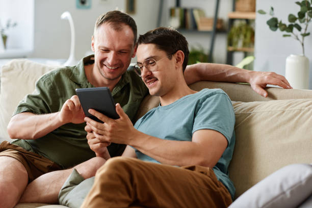 istock Friends with tablet pc at home 1323814823
