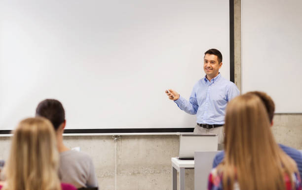 istock group of students and smiling teacher in classroom 1323816498