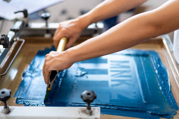 Close up of screen printing on shirts and textiles. Printing workshop with printing tool and color for screen printing. printing plate photos stock pictures, royalty-free photos & images