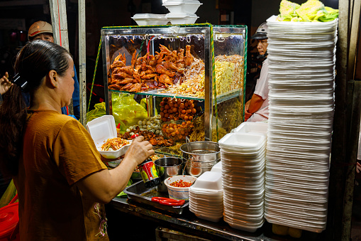 Cai Rang, Can Tho, Vietnam - December 27, 2019: People at the street food and night market of Cai Rang in Vietnam