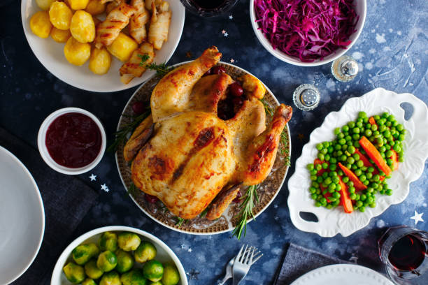 istock Festive dinner with chicken, brussels sprouts, peas, carrots, red cabbage salad, top view, selective focus 1323821666