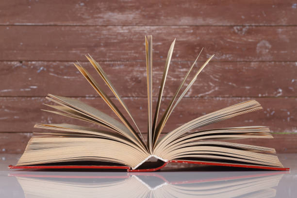 istock Science and education -  Open book wooden background.. Reflection 1323821771