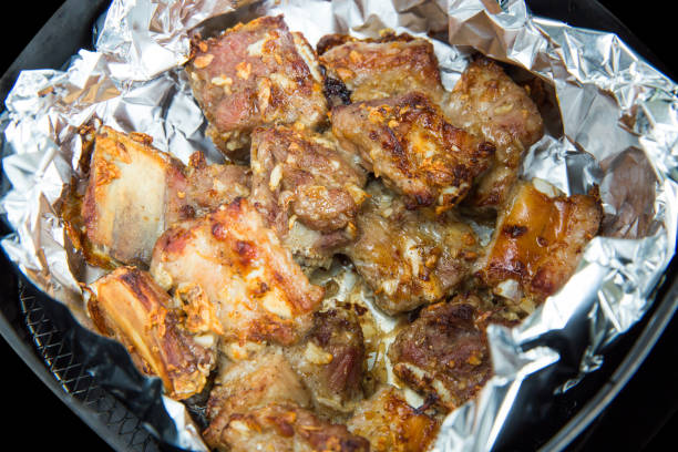 istock Fry pork ribs, Crispy pork ribs,on black isolated 1323827916