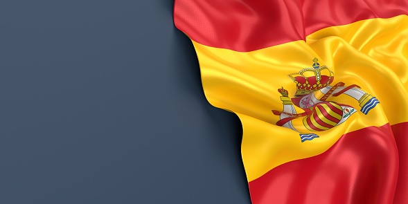 Partial Spanish flag is waving on blue gray background. Horizontal composition with copy space. Easy to crop for all your social media and print sizes.