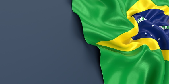 Partial Brazilian flag is waving on blue gray background. Horizontal composition with copy space. Easy to crop for all your social media and print sizes.