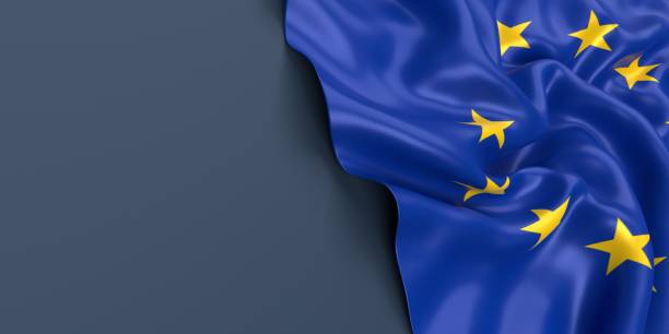 istock European Union Flag is Waving Against Blue Gray Surface 1323833766