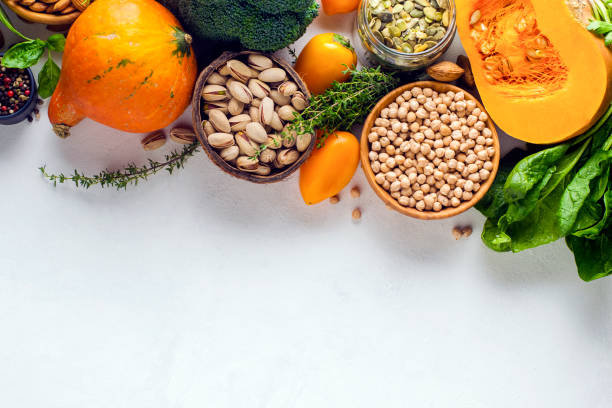 istock Pumpkin, nuts, peppers, herbs, chickpeas on a white plate with copy space. View from above. 1323836353