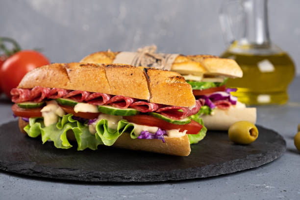 istock Home-made sandwich on a gray background and a board 1323839068
