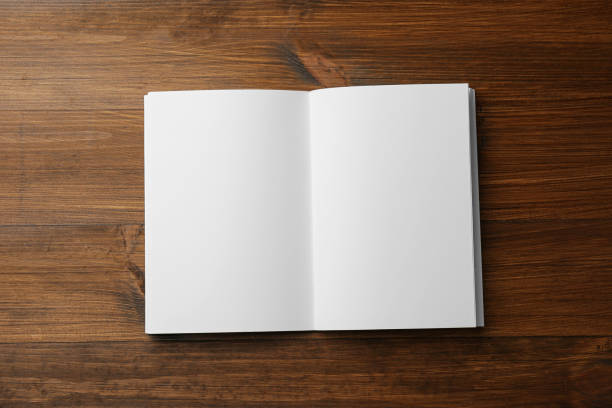 istock Open blank paper brochure on wooden table, top view. Mockup for design 1323839417