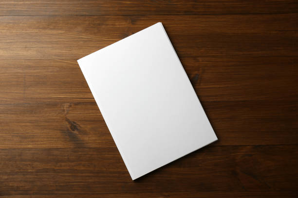 istock Blank paper brochure on wooden table, top view. Mockup for design 1323841502
