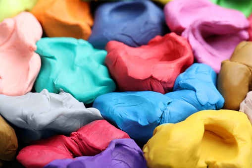 Pile of colorful plasticine as background, closeup