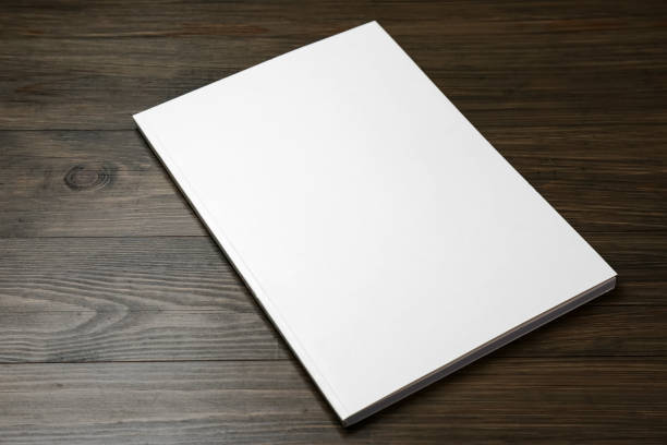 istock Blank paper brochure on wooden table. Mockup for design 1323841660