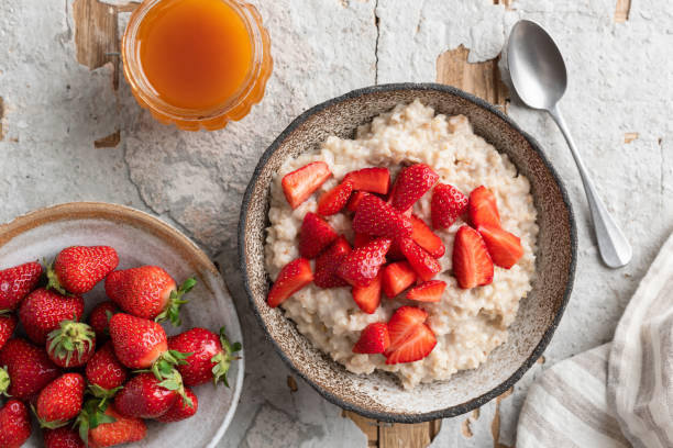 istock Oatmeal porridge bowl with strawberries 1323841855