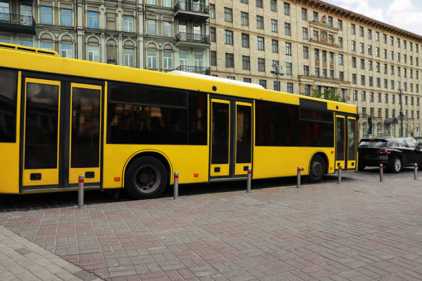istock Modern yellow bus with passengers on city street 1323841969